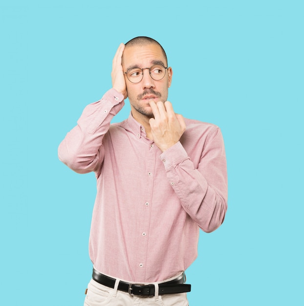 Crazy young man making a nervous gesture