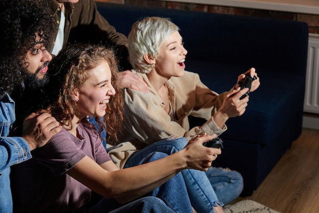 Crazy Young People Friends Enjoying Playing Videogame Game Console, Resting At Home, Resting At Home, In Casual Clothes, Games Console