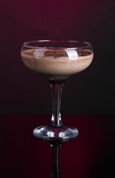 Cream cocktail on dark purple background