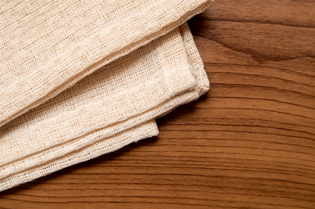 Cream colored cloth on the wood table