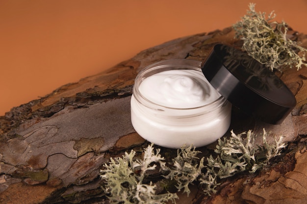 Photo cream for the face on the bark of a tree