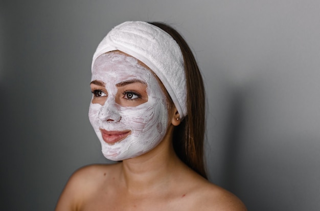 Cream on her face mask skin woman