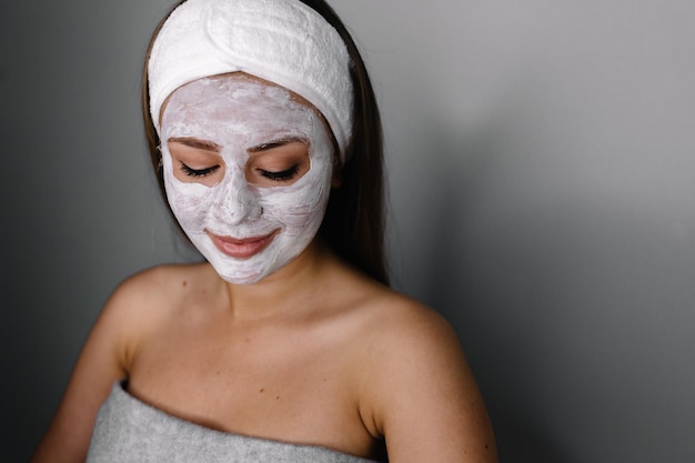 Cream on her face mask skin woman