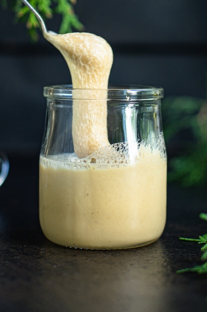 Cream honey in a transparent jar on the table sweet healthy dessert