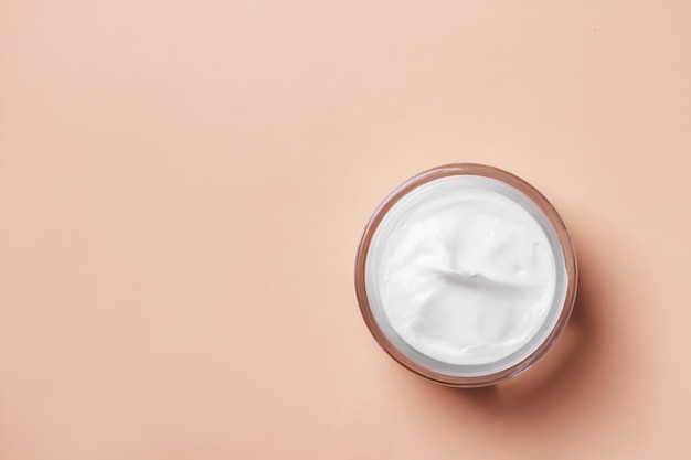 Cream jar of white on a beige background