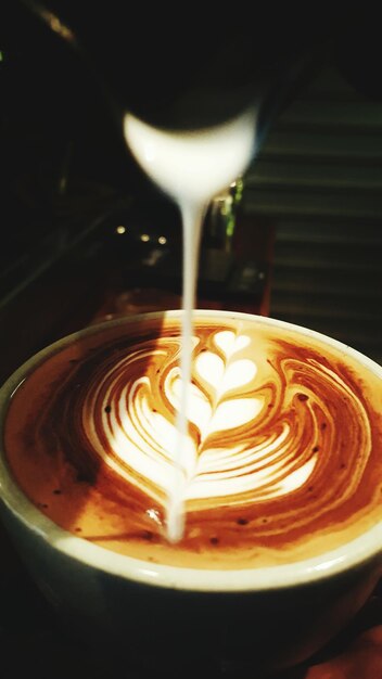 Photo cream pouring on coffee