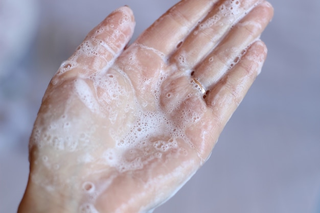 Cream shampoo in women's hands. Body care.