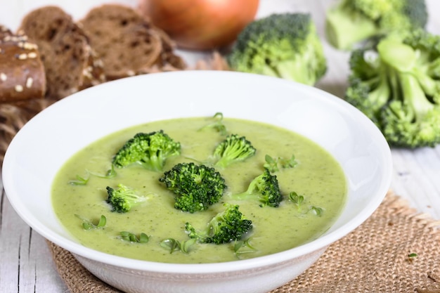 Cream soup from broccoli with slices of rye bread