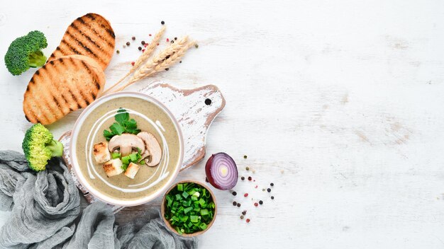 Cream soup of mushrooms in a bowl with toasted bread Dietary food Top view