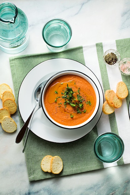 Cream soup of red lentils with tomatoes on the table. healthy vegan warming food for the whole family