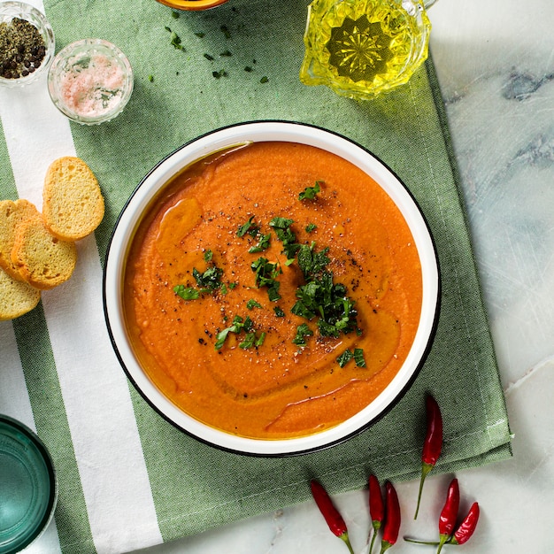 Cream soup of red lentils with tomatoes on the table. healthy vegan warming food for the whole family