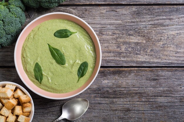 Cream soup with broccoli and baby spinach Bowl with croutons