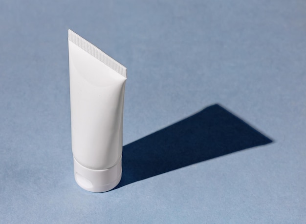 Cream tube mock up in perspective standing on blue background table