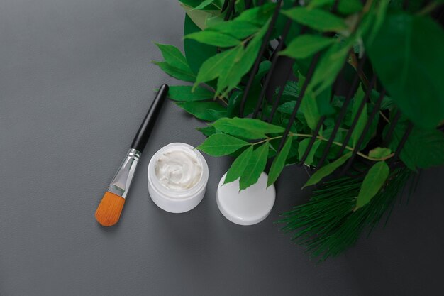 cream in a white jar on a gray background