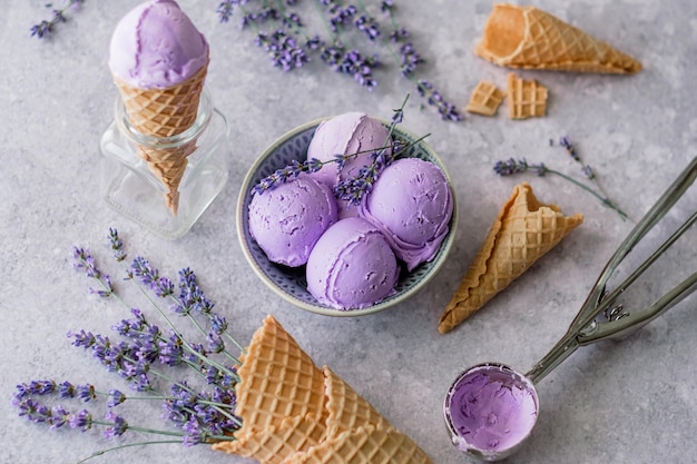 Creamy balls vegan lavender ice cream in plate with flowers French lavender.  flat lay, top view.