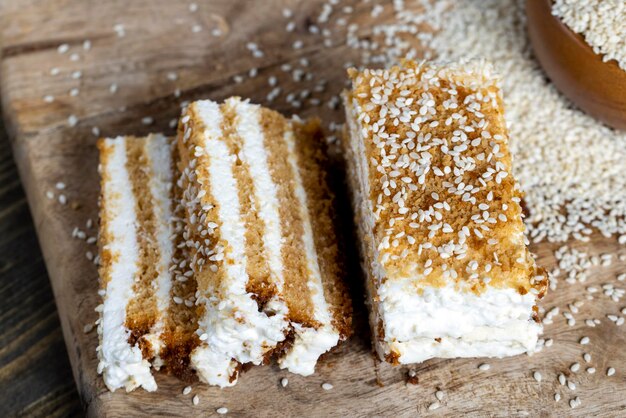 Creamy cream and caramel cakes sprinkled with sesame