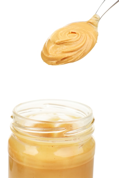 Creamy peanut butter in jar, isolated on white