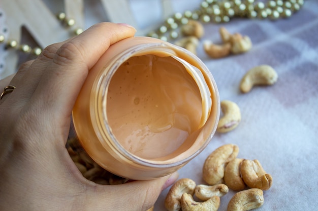 Creamy peanut butter and spoon on background.