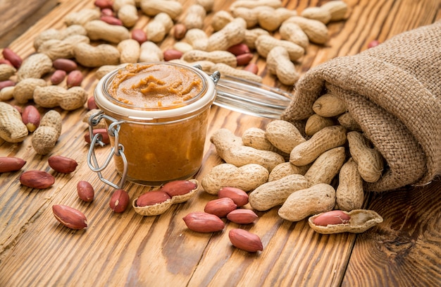 Creamy peanut butter on wood table.