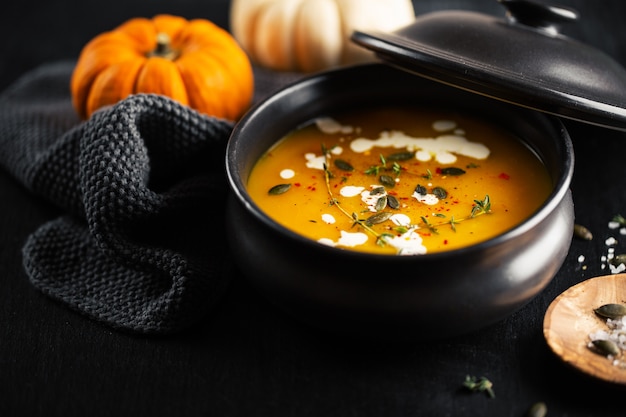 Creamy pumpkin soup served in bowl
