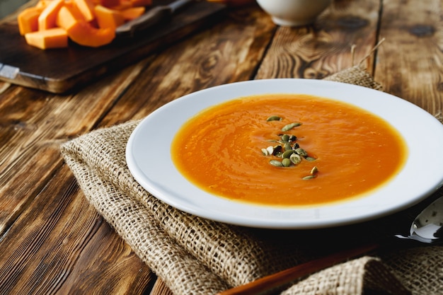 Creamy pumpkin soup in a white bowl