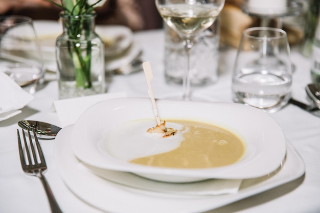 Creamy pumpkin soup with cream sauce and grilled shrimp restaurant concept celebration