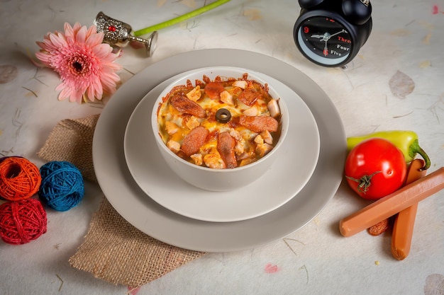 Creamy roma pasta with tomato in a plate top view on wooden background