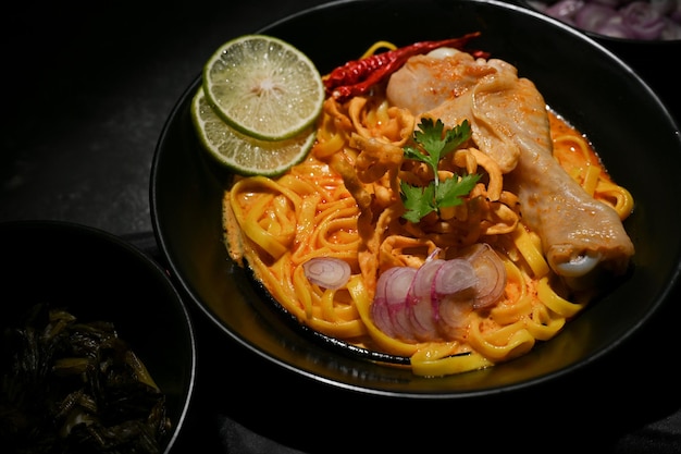 Creamy spicy curry noodles soup with egg noodles and chicken Khao Soi Kai