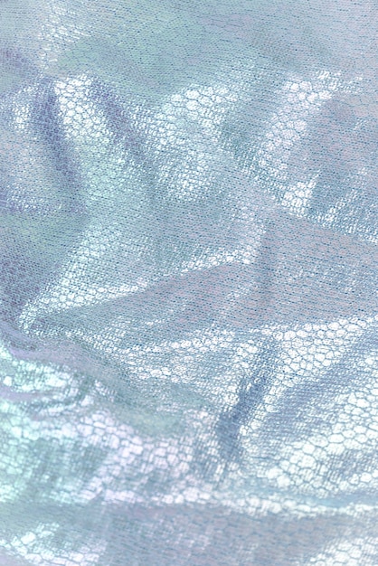 Creased textile texture, background template. Shine fabric light blue drapery. Sheene sharkskin fabrics for fashion dress. Shiny fashion clothing material sample.
