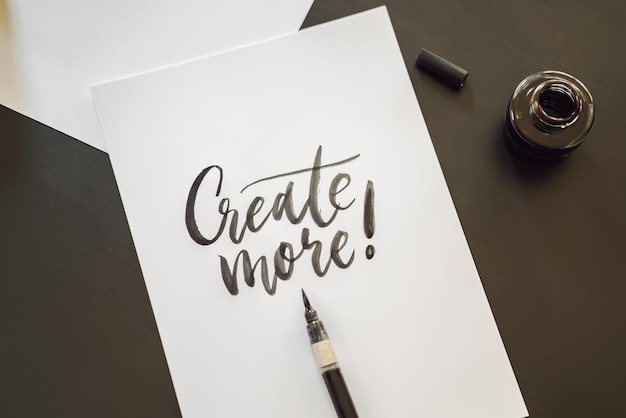 Creat more Calligrapher Young Woman writes phrase on white paper Inscribing ornamental decorated letters Calligraphy graphic design lettering handwriting creation concept