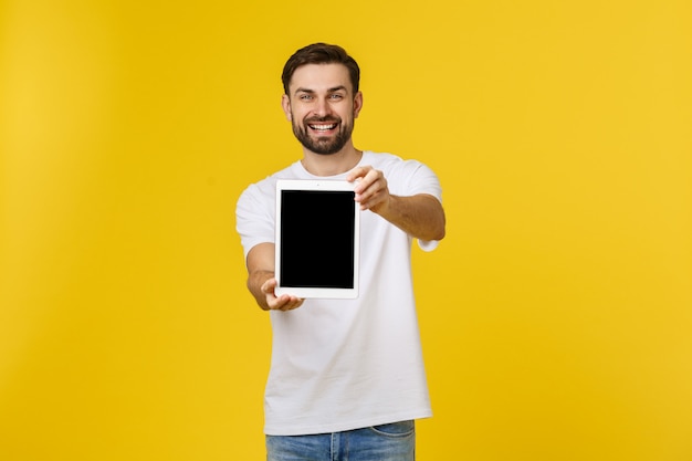 Creatieve jonge programmeur presenteert met een glimlach op zijn gezicht een tablet.
