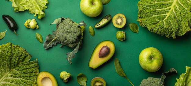 Creatieve lay-out food concept gemaakt van groene groenten en fruit op groene achtergrond