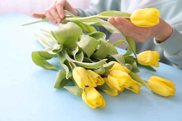 Creating a bouquet of yellow tulips