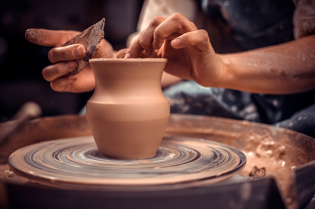 Creating a jar or vase. Master crock. Making clay jug. sculptor in the workshop makes a jug out of earthenware closeup.