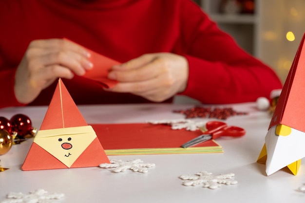 Creation of origami crafts from paper for Christmas and New Year