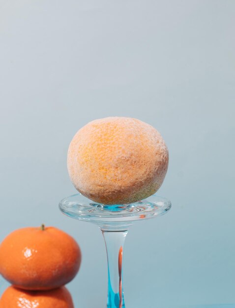 Photo creative arrangement of fresh and frozen tangerines and glasses close up