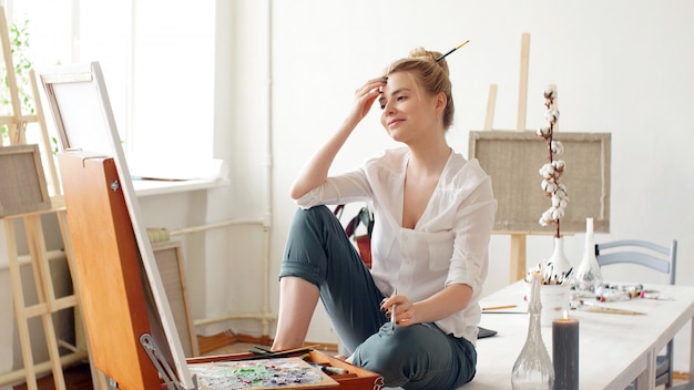 Creative artist draws in her studio