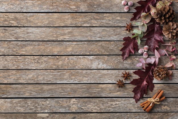 Creative autumn fall thanksgiving day composition with decorative dried leaves. Flat lay, top view, copy space, still life wooden background for greeting card. Floral, botanical concept.