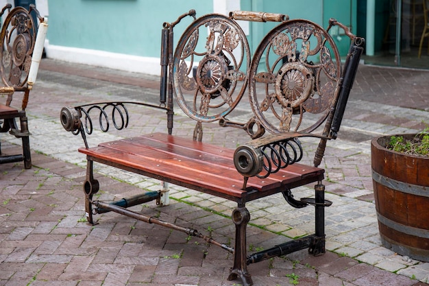 Creative bench made of iron and wood in steampunk style with elements of mechanisms