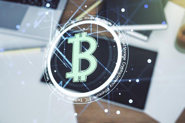 Creative Bitcoin concept and modern digital tablet on desktop on background top view Double exposure
