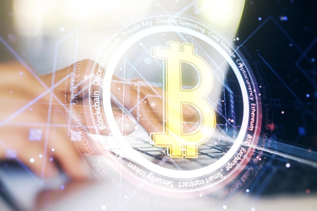 Creative Bitcoin concept with hands typing on computer keyboard on background Double exposure