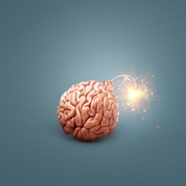 Creative brain bomb with a wick and sparks is lit on a dark\
blue background genius and idea concept idea headache and stress\
science and education