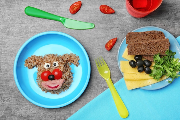 Photo creative breakfast for children on grey background top view