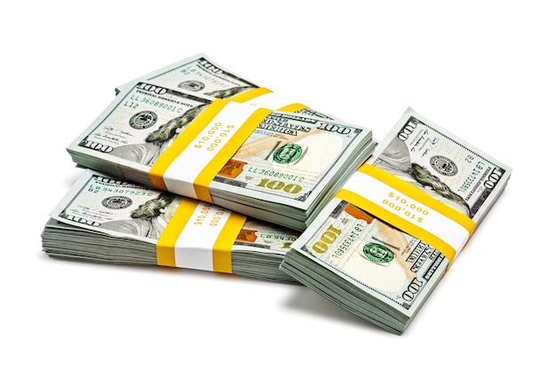 Creative business finance making money concept stacks of bundles of 100 US dollars bills isolated