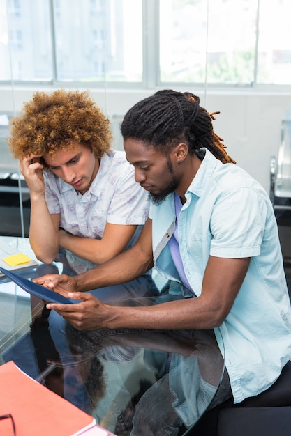 Creative business people looking at digital tablet