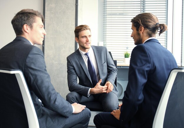 Creative business people meeting in circle of chairs