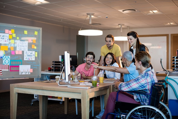 Photo creative business team discussing while working together on desktop pc in office