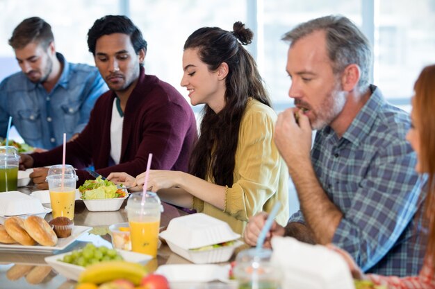 Creative business team having meal in office