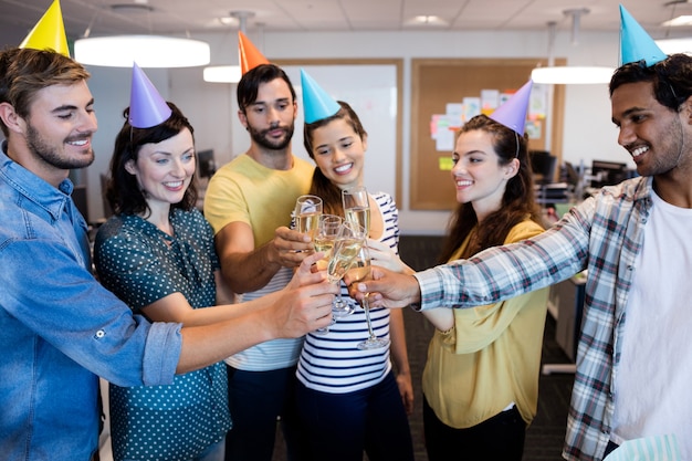 creative business team having a toast on colleagues birthday at office