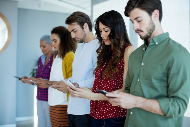 Creative business team using mobile phone in office